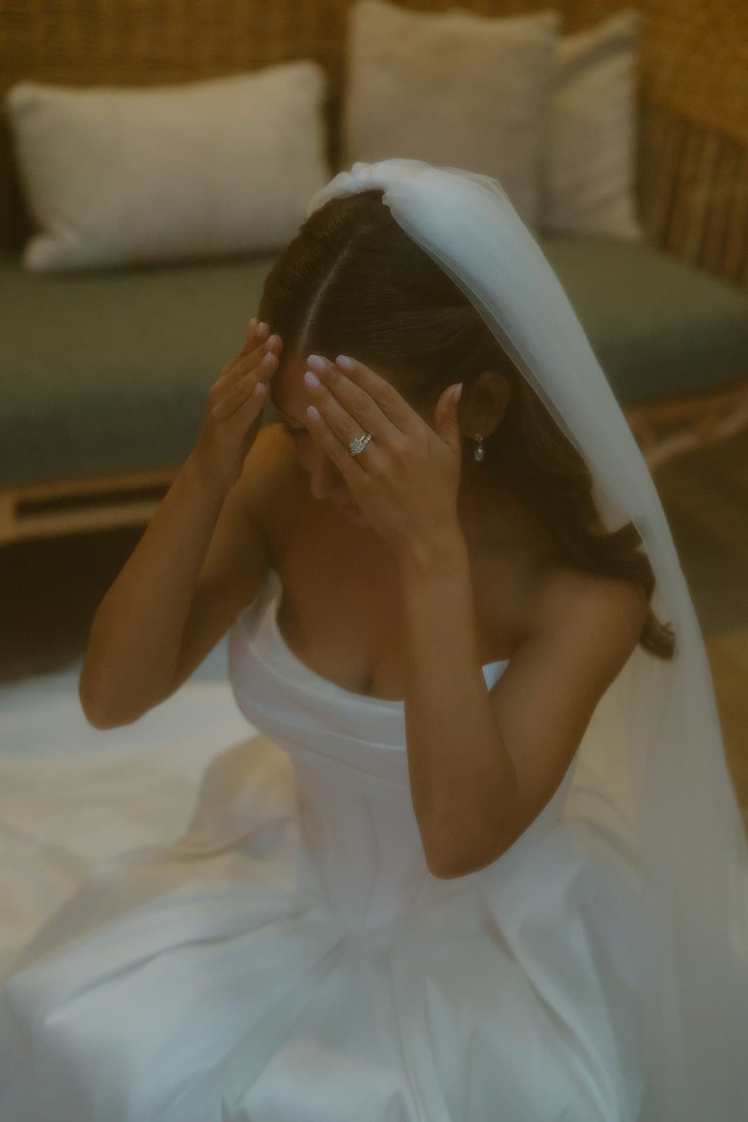 Bride adjusting her veil, intimate moment